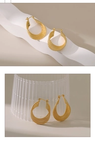 Detailed view of 18K gold braided texture on thick teardrop geometric hoop earrings