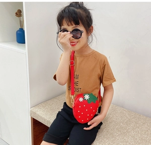 Close-up of a red strawberry-shaped kids crossbody bag with daisy and bead details