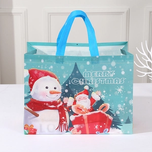 Teal non-woven Christmas gift bag featuring snowman and Santa Claus festive illustrations