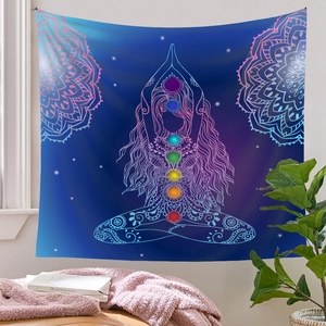 Detail of meditation tapestry with chakra symbols and mandala on a starry blue backdrop