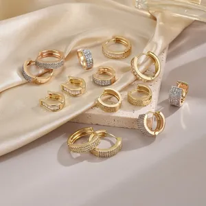 Elegant gold-plated geometric earrings set with sparkling cubic zirconia on silk