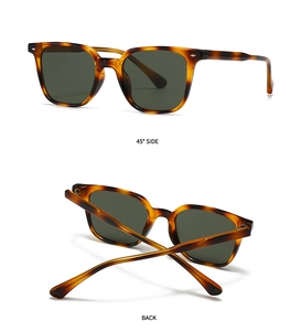 Detail view of tortoiseshell frame sunglasses with dark green lenses and metal accents