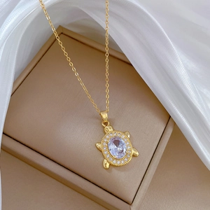 Close-up of turtle pendant necklace with large oval zircon and pavé crystal details