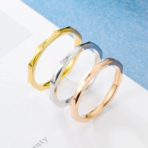 Detailed view of geometric rhodium-plated rings in gold, silver, and rose gold finishes