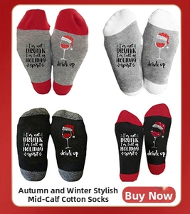 Macro view of Christmas socks with wine glass patterns and holiday spirit slogans