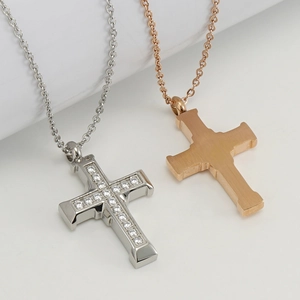 Detail of silver rhinestone and rose gold brushed stainless steel cross pendants