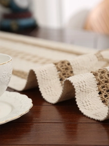Close-up of vintage orange cotton linen table runner with woven fringe and jute details