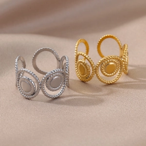 Detail of twisted rope design rings in gold and silver finish with adjustable open bands