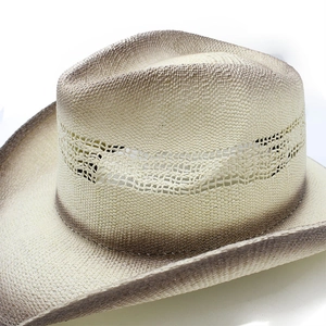 Detail of hand-woven straw cowboy hat with hollow mesh vents and brown gradient edges