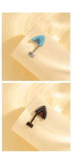 Detailed macro view of cat ear stud earrings featuring blue and black enamel with zircon