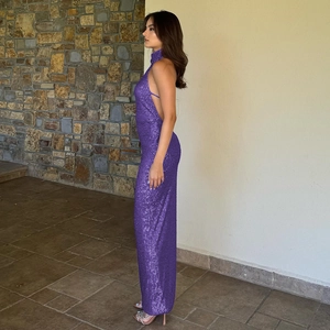 Detail of a purple sequined backless maxi dress with a halter neck and slim fit silhouette