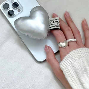 Silver padded heart phone grip and minimalist matching heart-shaped ring set detail