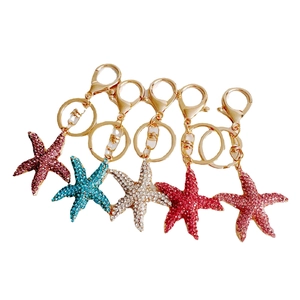 Sparkling rhinestone starfish keychains in five colors with gold plated metal rings