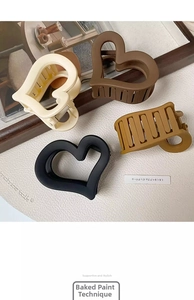 Close-up of matte finish heart shark clips in cream, brown, ginger, and black colors