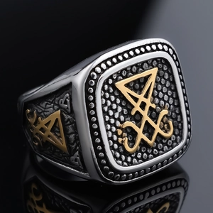 Macro shot of stainless steel Lucifer sigil ring with gold finish detail and reflection