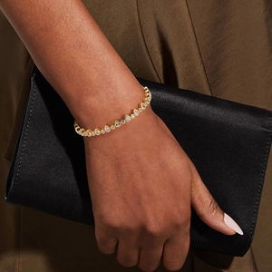Detailed close-up of a 925 silver 18K gold-plated tennis bracelet with teardrop zircons