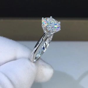 Close-up of classic six-prong silver engagement ring with large round-cut sparkling stone