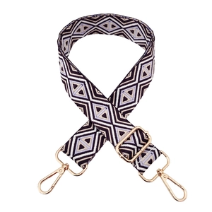 Detail of adjustable geometric diamond weave strap with gold metal spring hooks