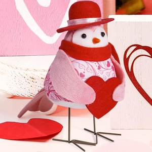 Detail of pink floral bird plush with red heart and scarf for Valentine decor