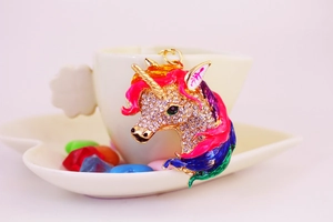 Detail of colorful unicorn head keychain with sparkling rhinestones and gold enamel finish