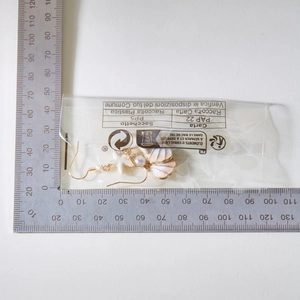 Detailed view of starfish and seashell drop earrings with size scale on white background