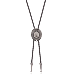 Detail of silver cowboy hat alloy slide and black braided leather cord of the bolo tie