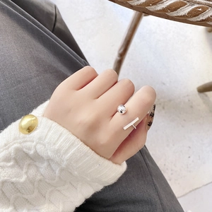 Close-up of S925 sterling silver open ring with bead and T-bar design on index finger
