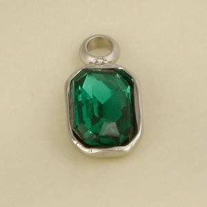 Macro detail of rectangle cut green gemstone pendant with silver stainless steel bezel setting