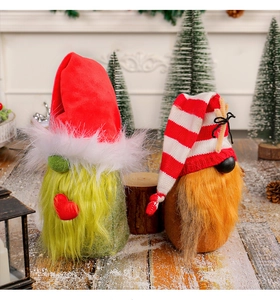 Detailed view of plush Christmas gnomes with red heart patterns on festive snowy background