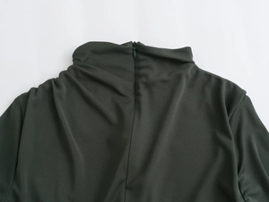 Detail shot of a dark green midi dress featuring a high collar and invisible back zipper