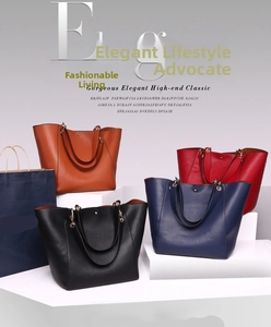Detailed display of tote bags in black, brown, red, and blue on white geometric stands