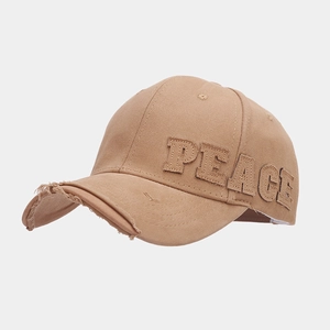 Detail showing vintage distressed brim and PEACE letter embroidery on khaki baseball cap