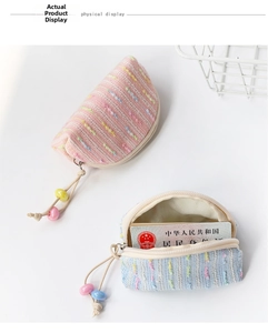 Close-up of cute fabric coin purses in pink and blue with decorative beads and zippers
