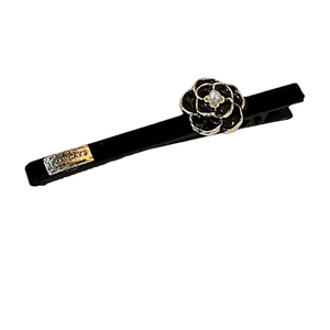 French vintage black camellia hair clip with pearl center and metal label detail