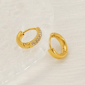 Classic 18K gold-plated titanium hoop earrings with sparkling inlaid zircons on white fabric