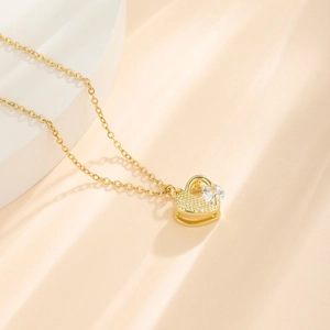 Gold titanium steel heart necklace with cubic zirconia pendant on a modern white display
