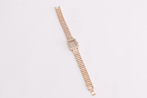 Detailed macro view of rose gold square watch fully encrusted with sparkling rhinestones