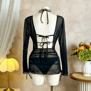 Detailed back view of black mesh beach cover-up featuring elegant bow tie closures