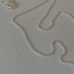 Minimalist 925 sterling silver bead chain necklace with spring clasp closure on white base