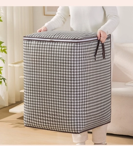 Detail of houndstooth storage bag featuring thick handles and a durable two-way zipper