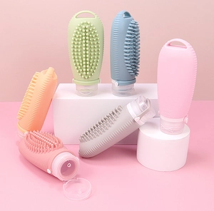 Detail of 100ml silicone travel bottles with built-in massage brush in various colors