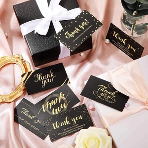 Elegant black and gold foil thank you cards for small business on pink silk background