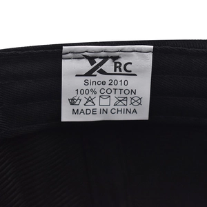 Macro view of 100% cotton wash label and internal stitching on black baseball cap