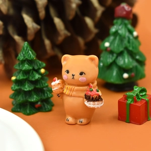 Macro shot of an orange resin Christmas bear with mini cupcake and festive holiday props