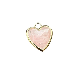 Natural faceted pink quartz heart pendant with gold metal rim on white background