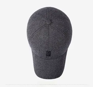 Top view of dark grey herringbone wool baseball cap with black logo tag detail