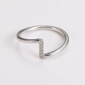 Macro shot of silver wavy stainless steel ring featuring 6 small zircon stones