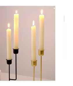 Modern minimalist metal candle holders in matte black and brushed gold with lit candles