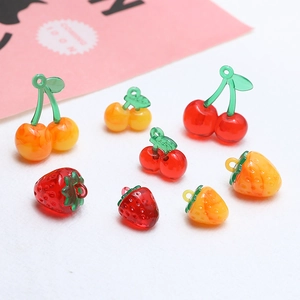 Macro detail of resin cherry and strawberry charms for DIY jewelry making accessories