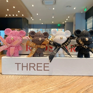 Set of four knitted texture resin bear keychains in pink, black, white, and brown colors